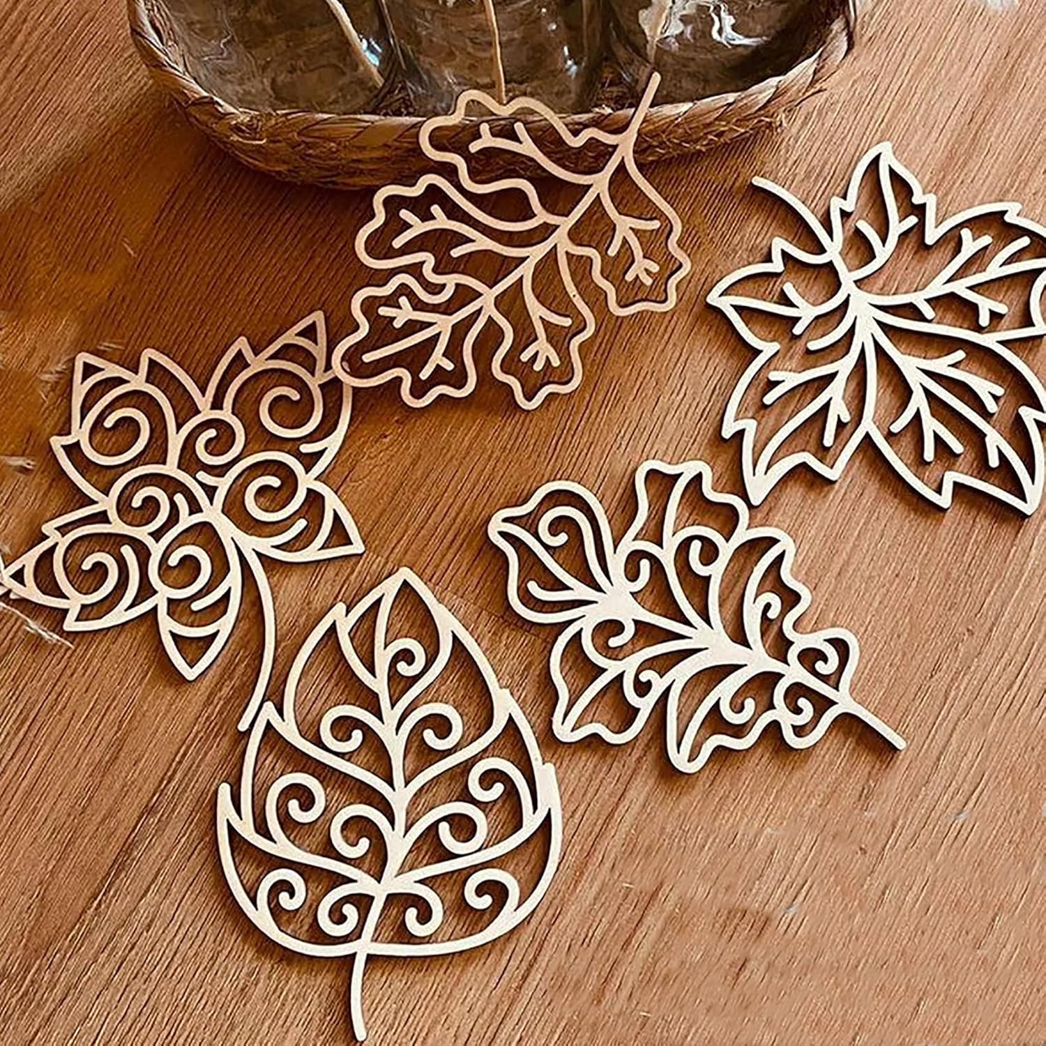 Decorative leaf-shaped cutouts on a wooden surface