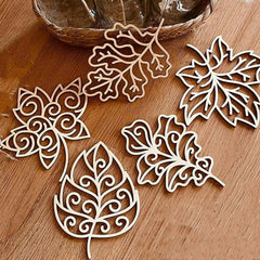 Decorative leaf-shaped cutouts on a wooden surface