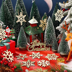 Christmas-themed display with trees, ornaments, and 'Merry Christmas' sign on a red base.