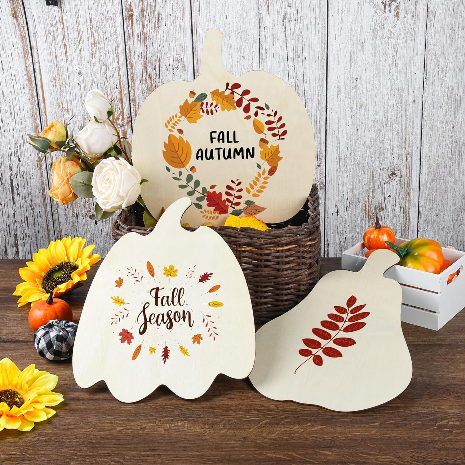 Decorative signs with 'Fall Season' and 'Fall Autumn' text, surrounded by autumn-themed items on a wooden surface.