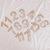 Wooden numbers on a textured white background