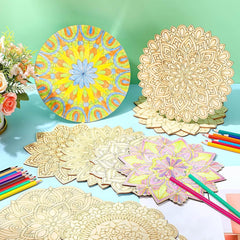 Colorful mandala designs on paper with colored pencils and flowers on a green background