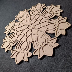 Wooden floral cutouts on a dark gray background