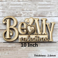 Wooden decorative sign with 'Be My Valentine' text on a wooden background