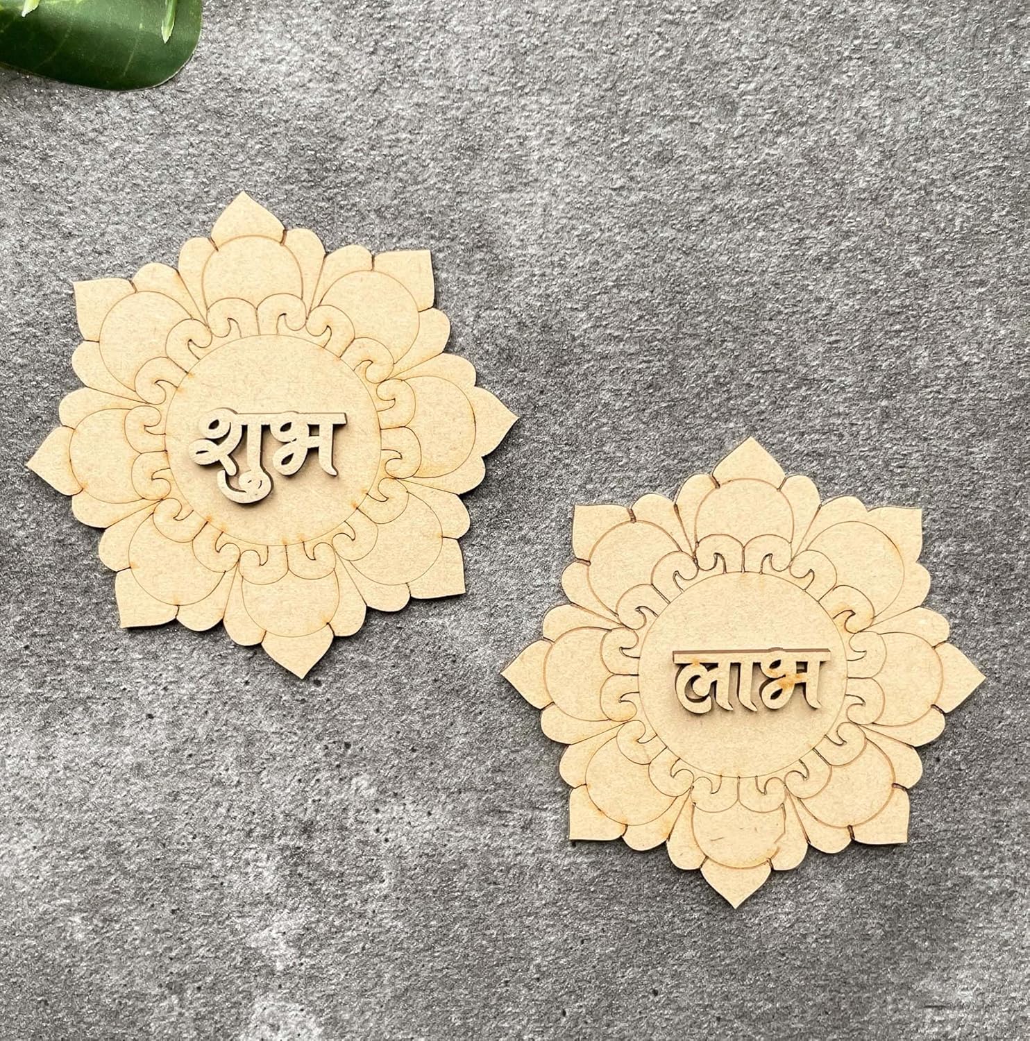 Two decorative wooden pieces with engraved text on a gray surface