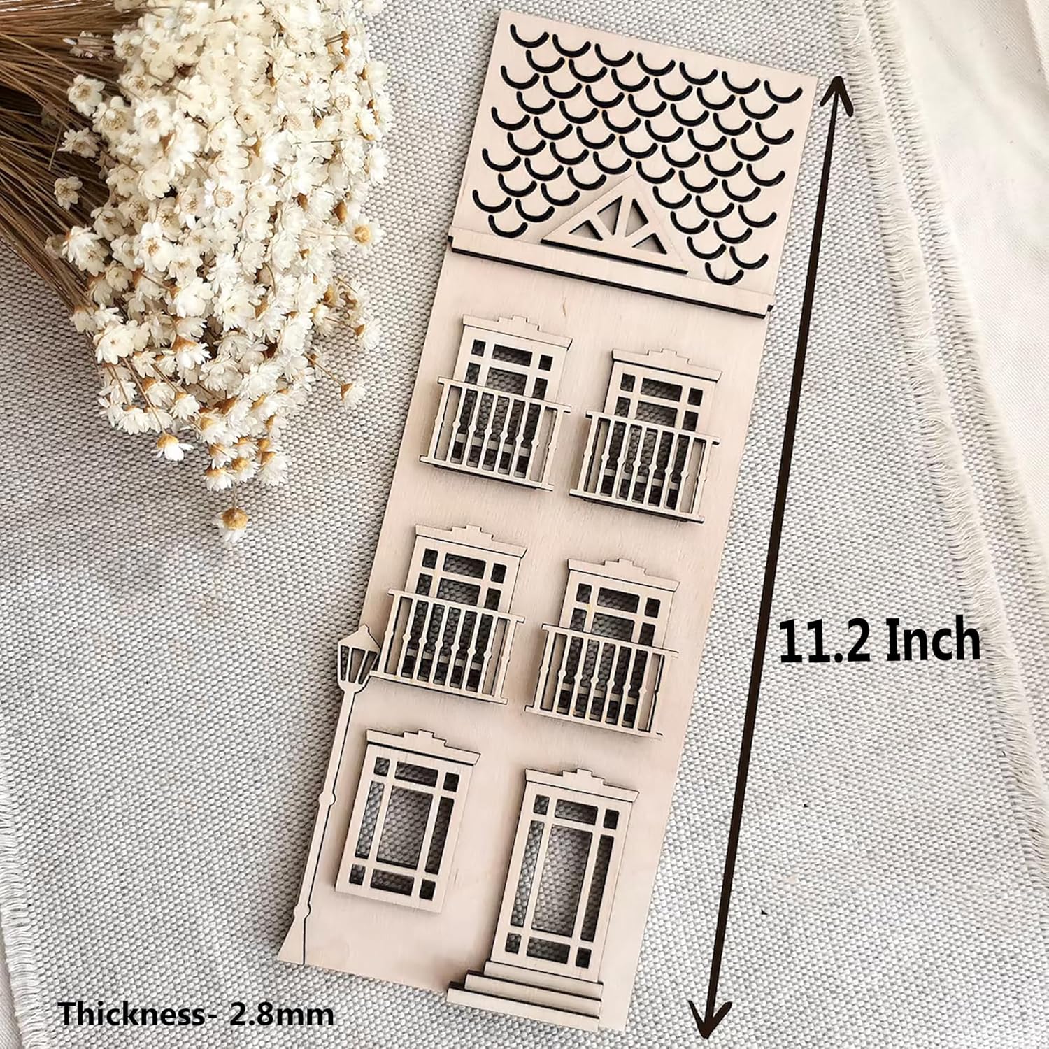 Decorative wooden window shapes with measurement details on a textured surface.
