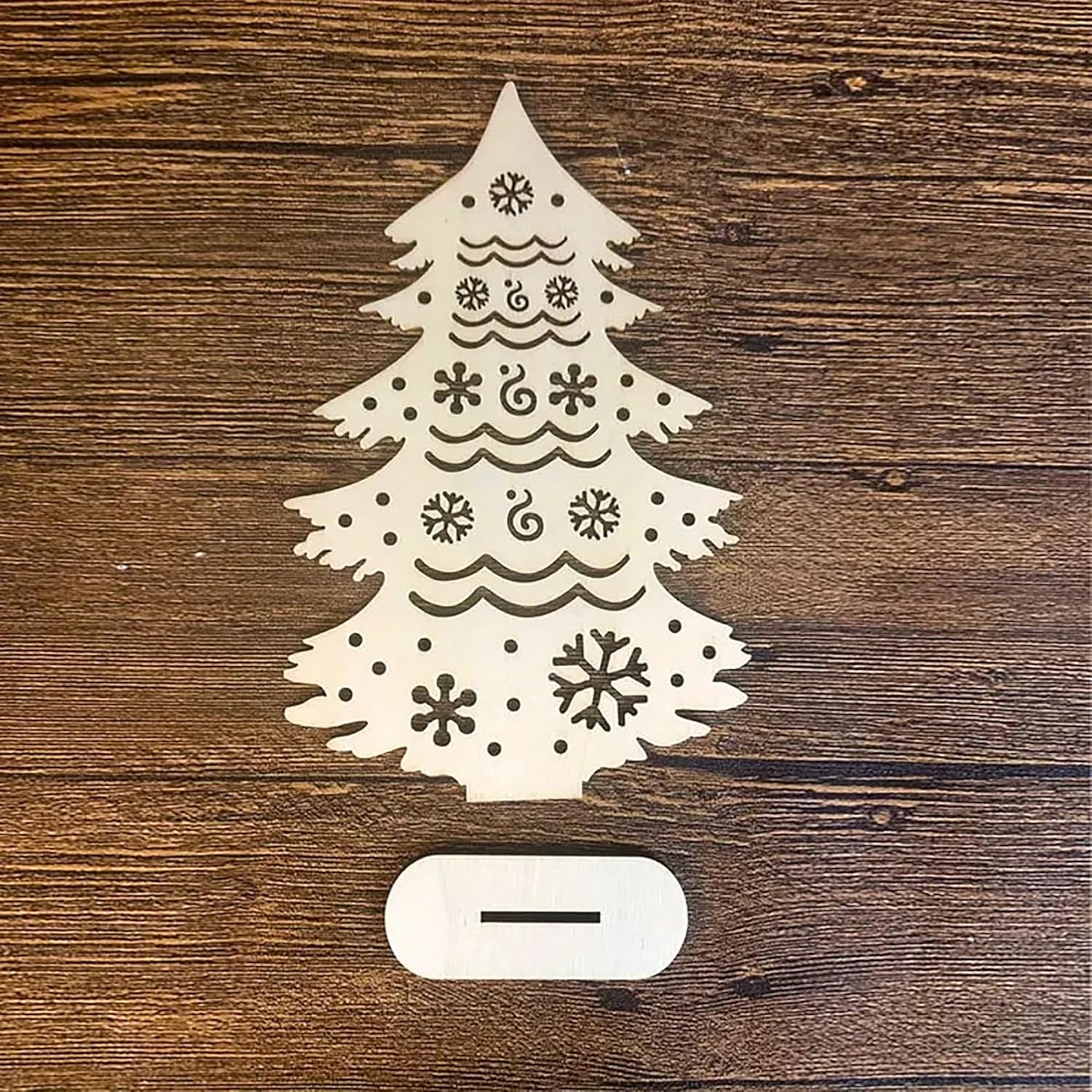 Decorative Christmas tree light on a wooden surface