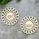 Two decorative wooden pieces with intricate patterns and engraved text on a gray surface.