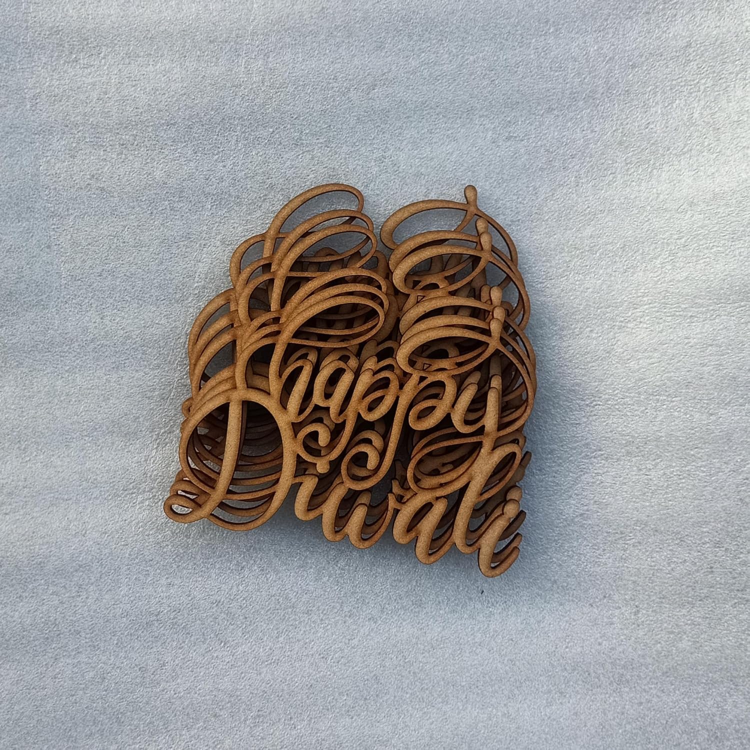 Stack of wooden coasters with 'Happy Holidays' text on a light gray background