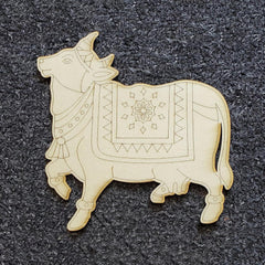 Decorative wooden bull figure with intricate patterns on a dark textured background