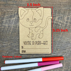 Kraft paper card with cat design and measurements on a wooden surface, with markers below.
