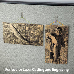 Two wooden plaques with laser-cut images of a fish and a person holding a fish, hanging on a textured wall.