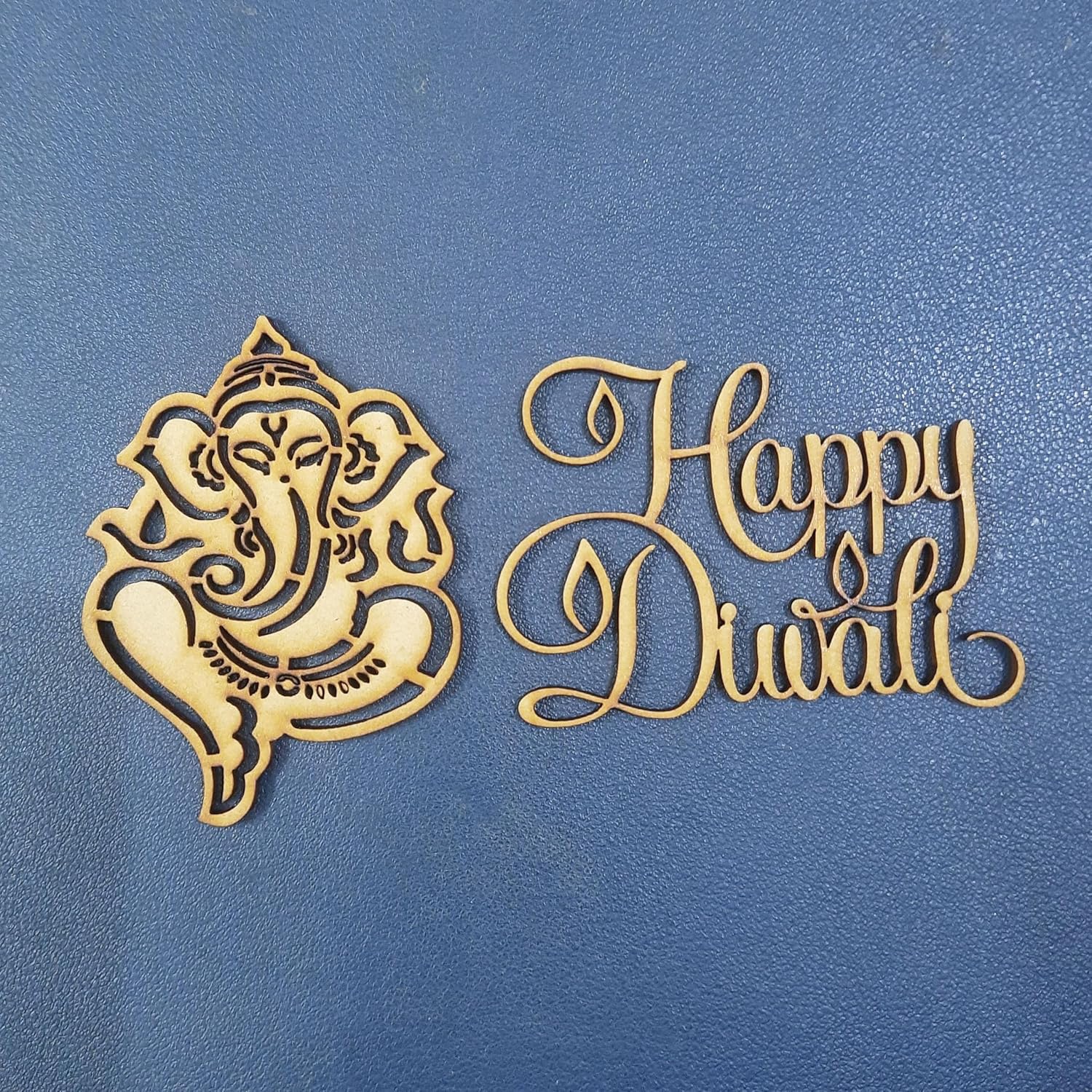 Decorative cutout of Lord Ganesha and 'Happy Diwali' text on a blue background