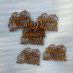 Wooden 'Happy Diwali' decorations on a textured gray background