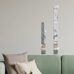 Decorative wall mirrors with geometric patterns on a neutral wall above a sofa.