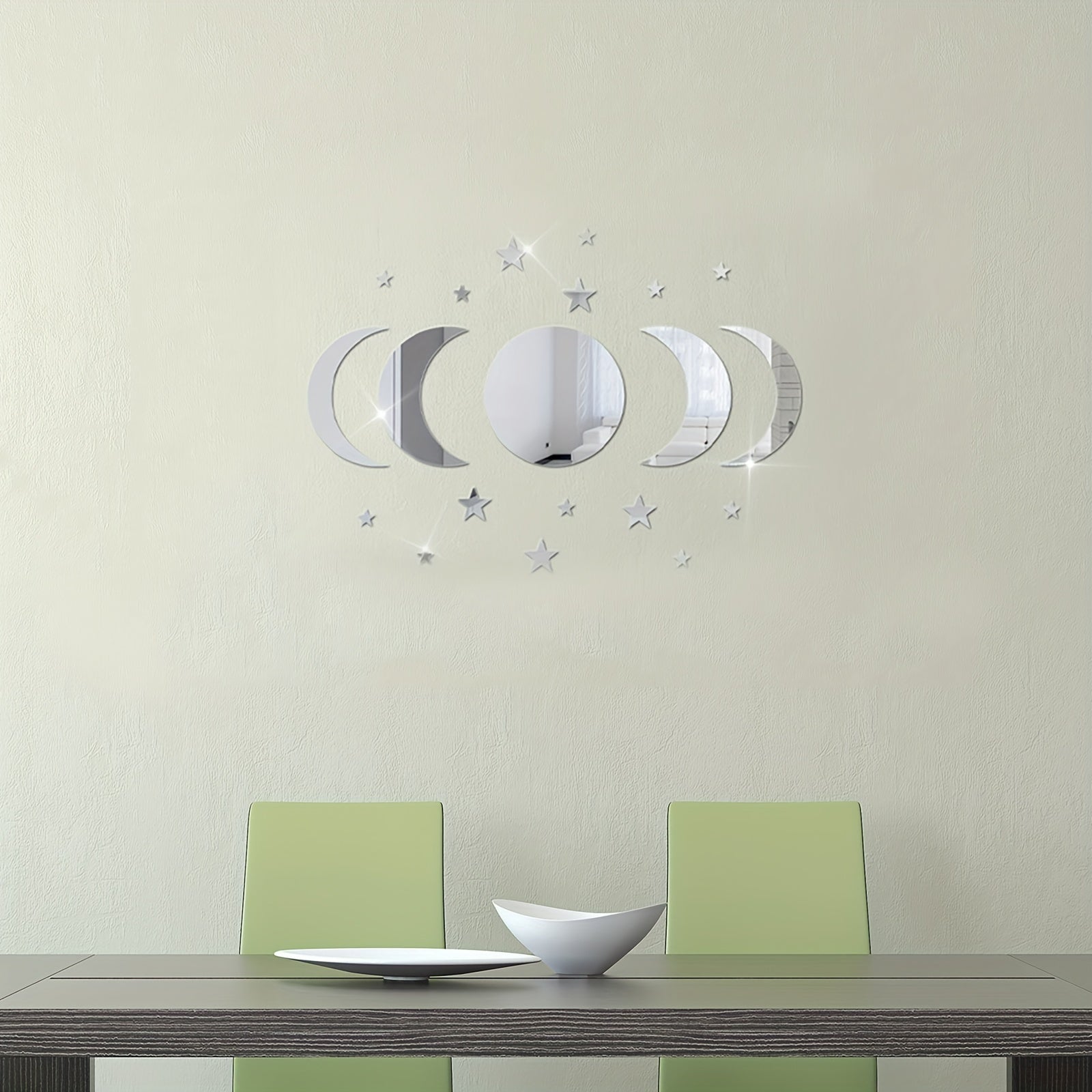 Dining room with a table and chairs, featuring decorative wall mirrors on a light green wall.