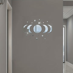 Decorative wall sticker with moon phases and stars on a gray wall.