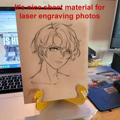 Cardboard sheet with anime character drawing on a stand, with text about laser engraving photos.