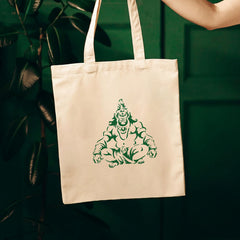 Beige tote bag with green graphic design on a dark green background