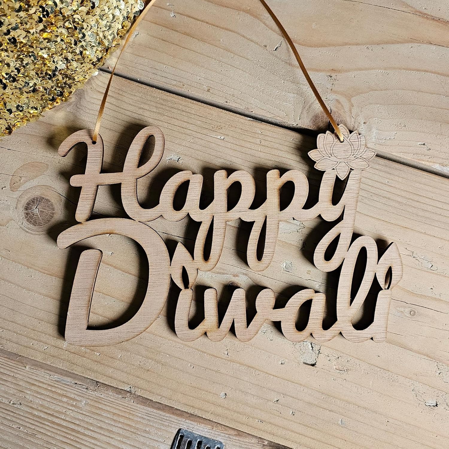 Wooden decorative sign with 'Happy Diwali' on a wooden surface
