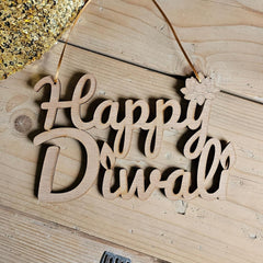 Wooden decorative sign with 'Happy Diwali' on a wooden surface