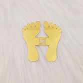 Gold footprints with a swastika symbol on a light gray background