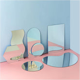 Set of geometric mirrors on a pink and blue gradient background