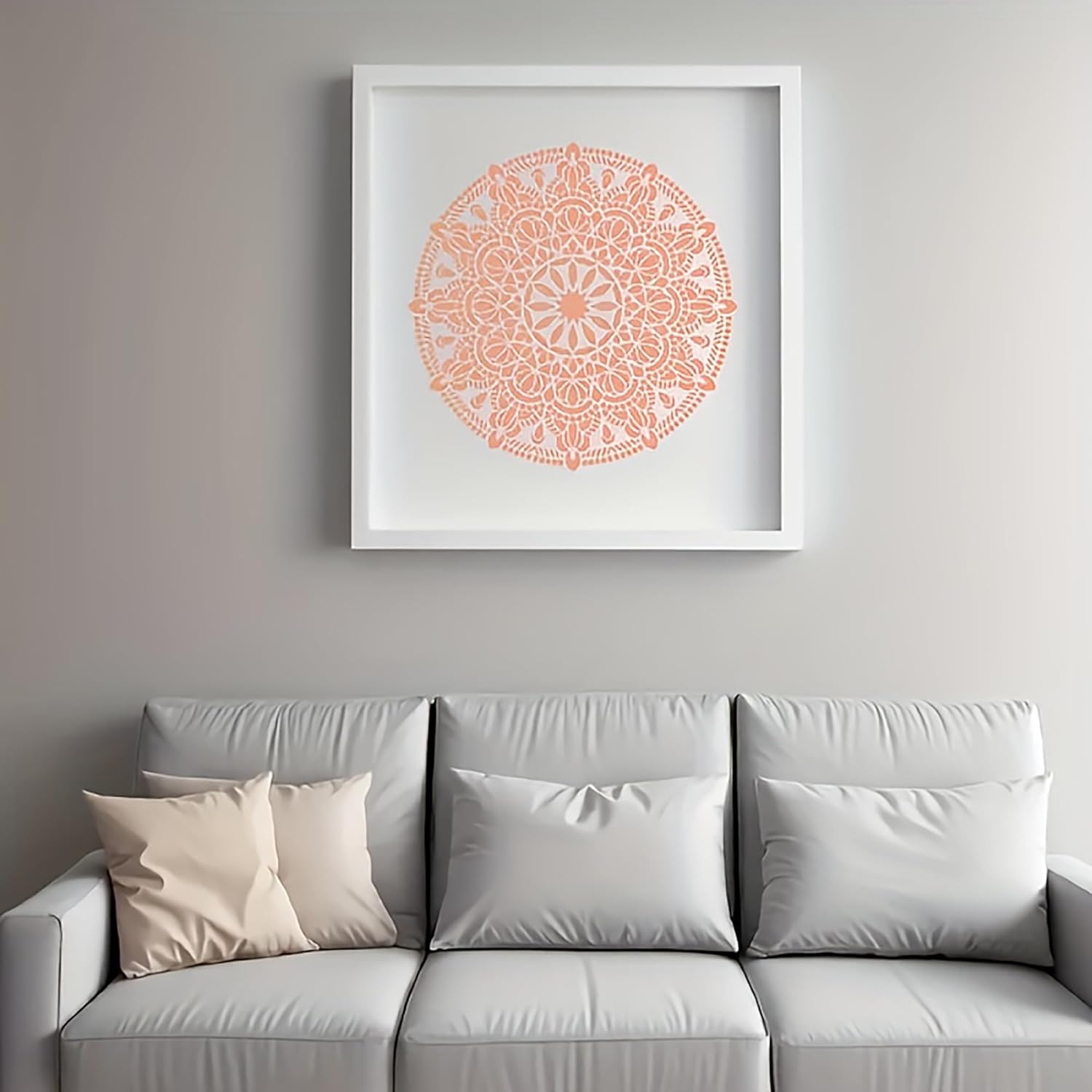 Framed mandala art above a gray sofa with decorative pillows.