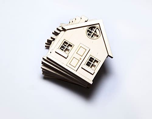 Stack of wooden house models on a white background