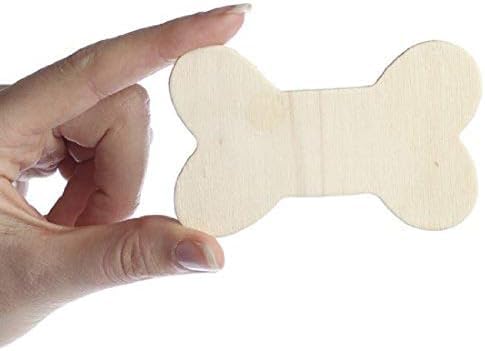 Hand holding a bone-shaped wooden cutout against a white background