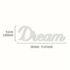 Wooden word decoration with 'Dream' and measurements on a white background