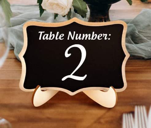 Table number '2' sign on a wooden stand with a black background
