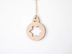 Wooden Christmas ornament with star cutout on a white background