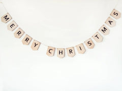 Merry Christmas banner made of wooden letters on a white background