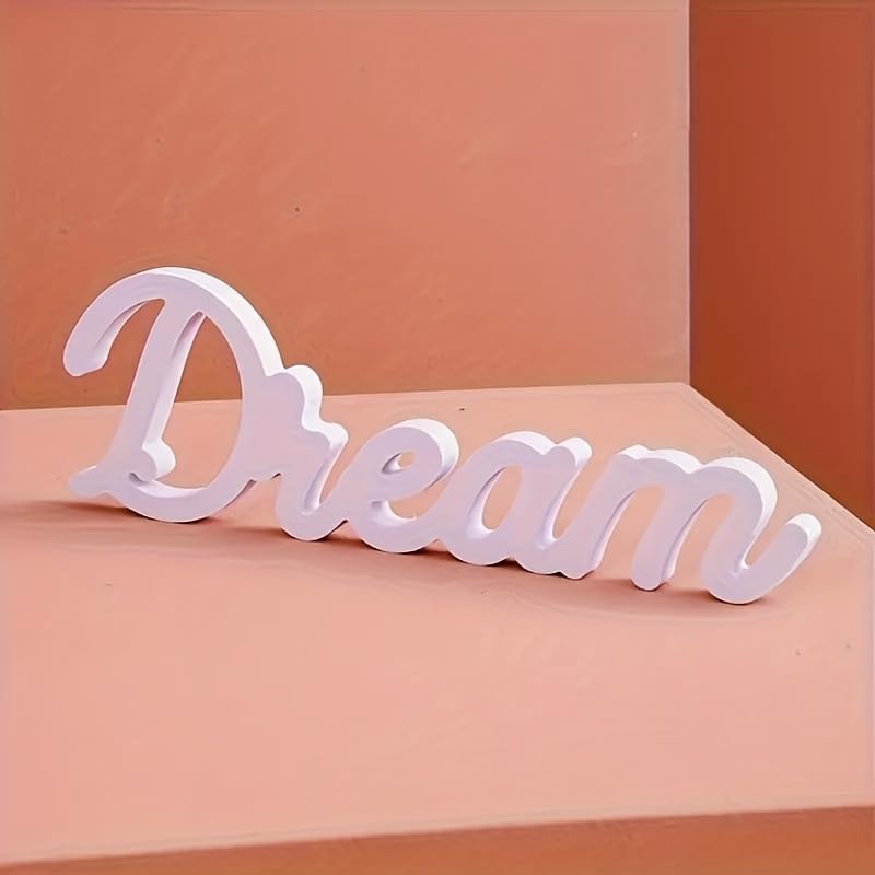 White decorative word 'Dream' on a peach-colored background