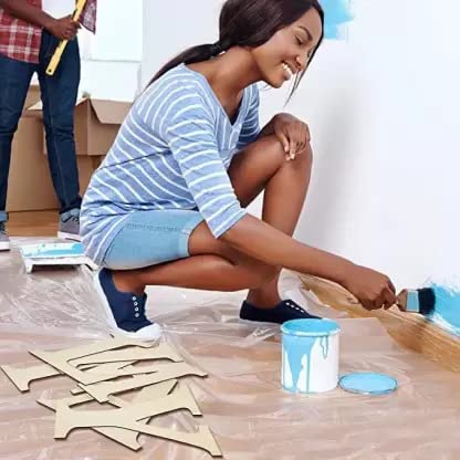 Woman painting a wooden floor with a man in the background.