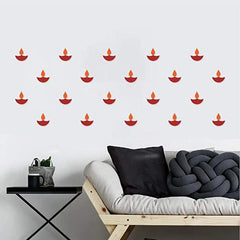Wall with decorative red candle decals above a sofa with pillows.