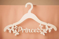 White hanger with 'Princess' text on a peach background