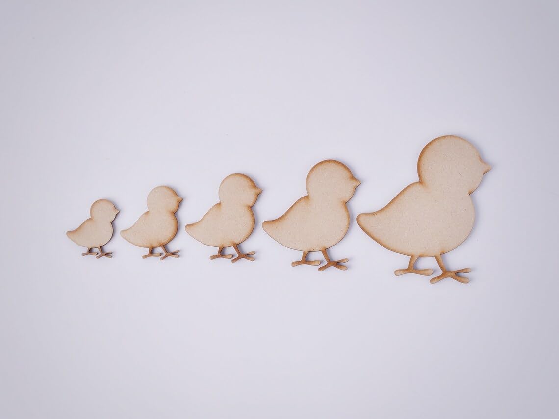 Five wooden cutout shapes of chicks on a white background