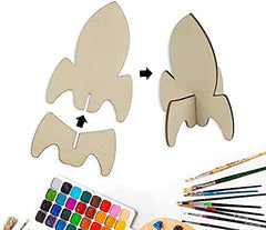 Wooden rocket-shaped craft kit with paint, brushes, and watercolors on a white background