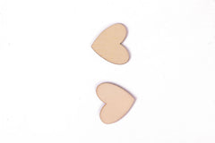 Two beige heart-shaped pasties on a white background