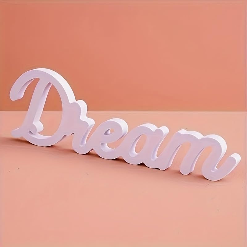 White decorative word 'Dream' on a peach background