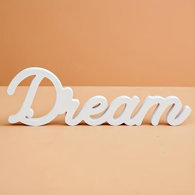 White decorative word 'Dream' on a beige background