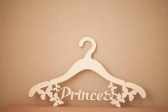 White hanger with 'Princess' text on a beige background