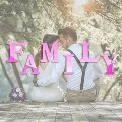 Couple embracing with 'FAMILY' text in pink against a blurred floral background