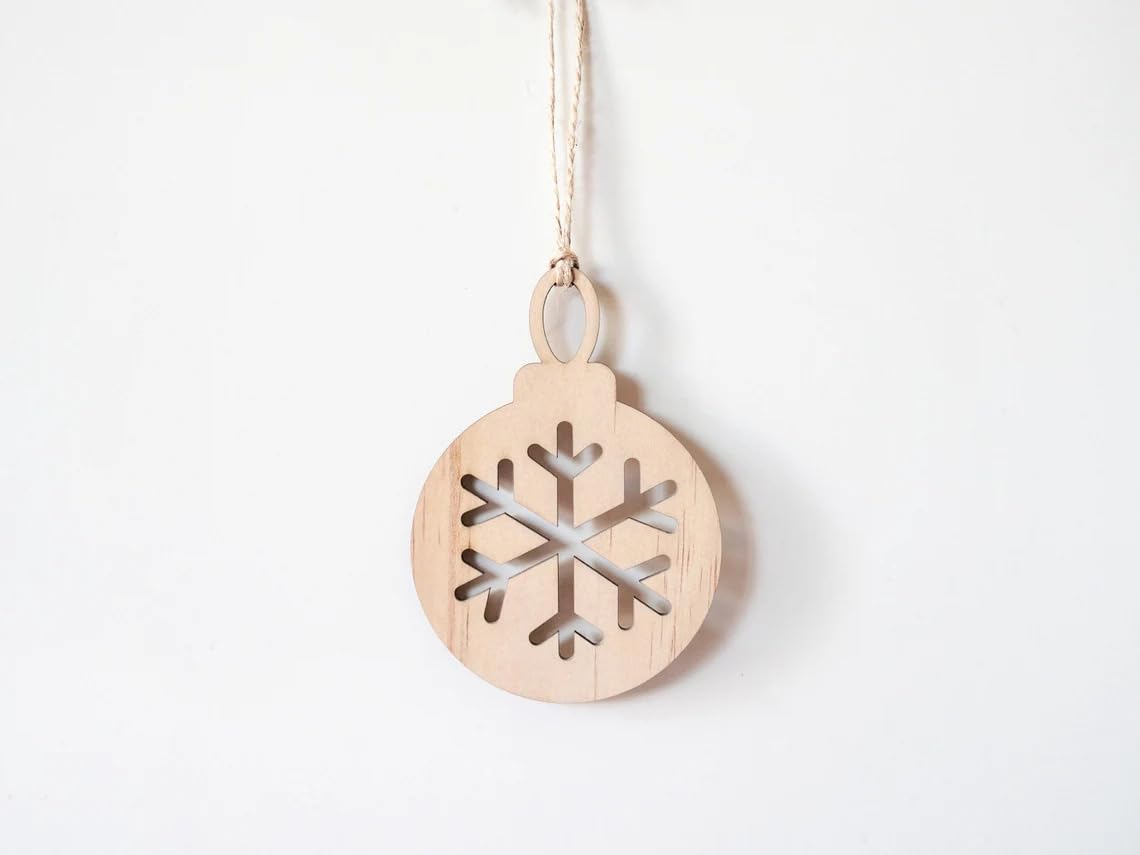 Wooden snowflake ornament hanging on a white background