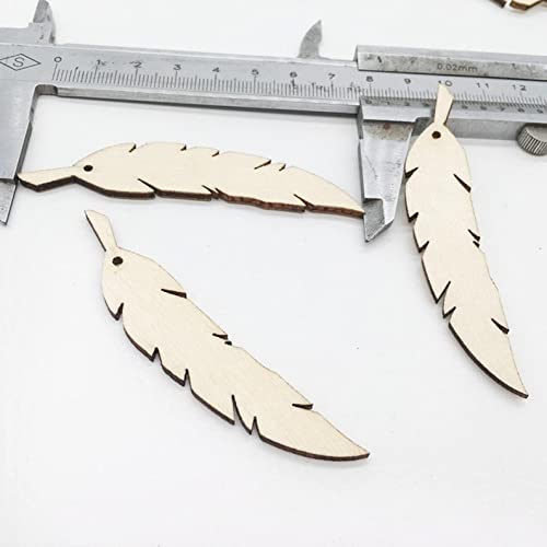 Wooden feather-shaped cutouts with a ruler for scale on a white background