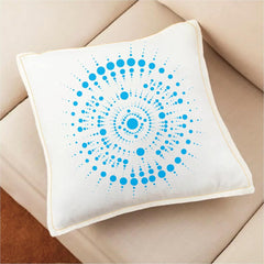 Decorative pillow with blue circular pattern on a beige couch