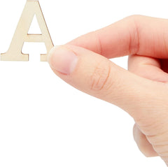 Hand holding a wooden letter 'A' on a white background