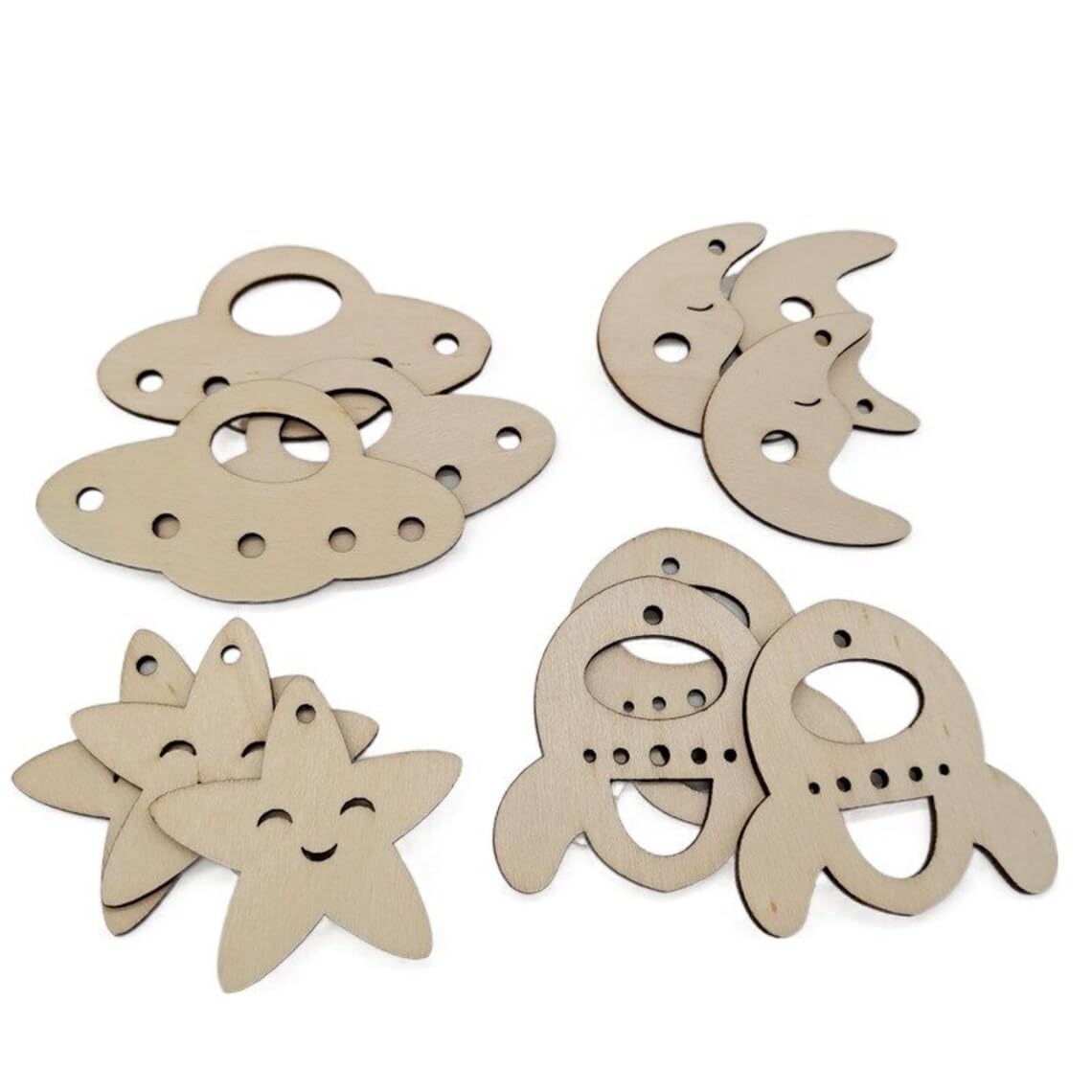 Set of wooden cutouts shaped like a fish, moon, star, and shell on a white background.